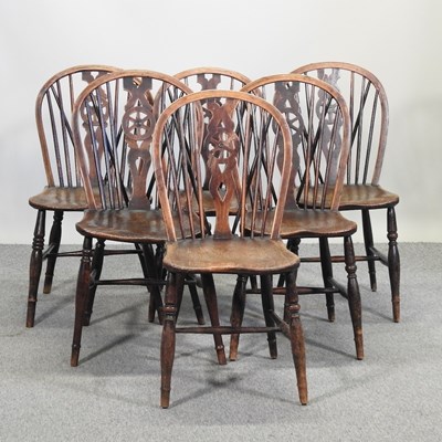 Lot 615 - A set of six elm seated wheelback dining chairs