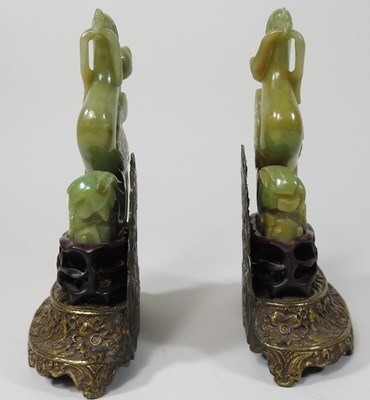 Lot 27 - A pair of Chinese carved jade coloured stone birds