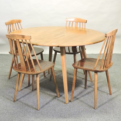 Lot 502 - An Ercol light elm drop leaf dining table