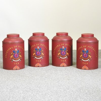 Lot 669 - A set of four red tole style tea canisters