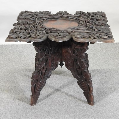 Lot 441 - An early 20th century Indian carved occasional table