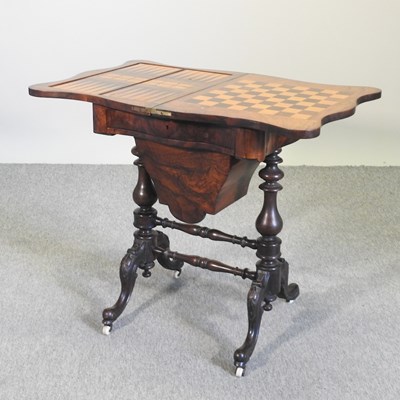 Lot 200 - A Victorian walnut games/work table