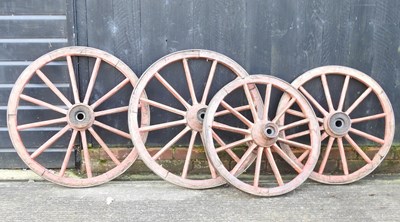 Lot 27 - A pair of red painted wooden cartwheels
