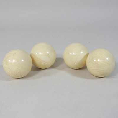 Lot 84 - Four simulated ivory billiards balls