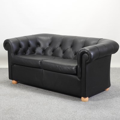 Lot 350 - A modern black upholstered chesterfield sofa