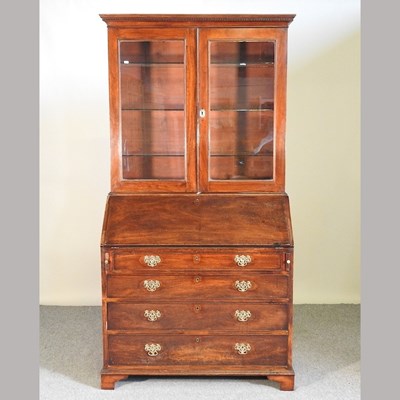 Lot 506 - A George III mahogany bureau with an associated bookcase top