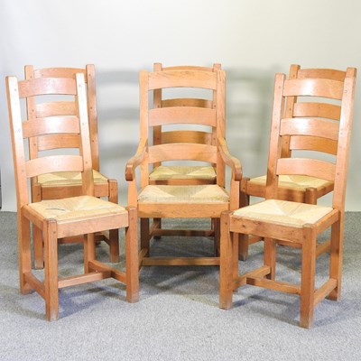 Lot 476 - A set of six light oak ladder back dining chairs