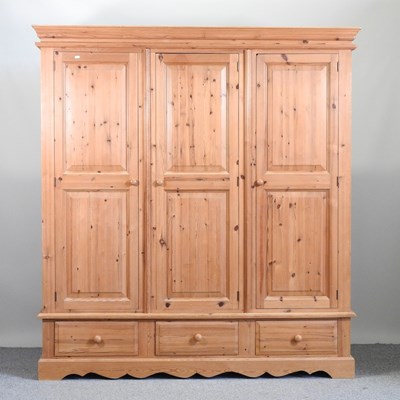 Lot 523 - A modern pine triple wardrobe