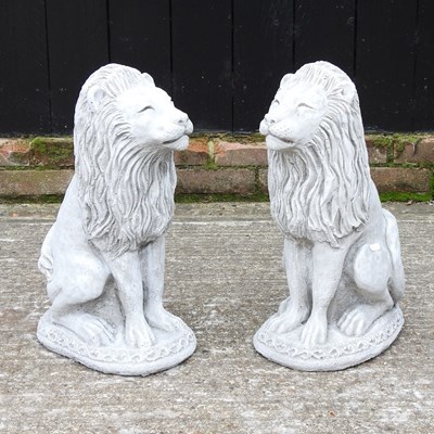 Lot 332 - A pair of cast stone seated lions