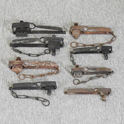 Lot 218 - A collection of eight 19th century iron gin traps