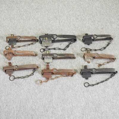 Lot 457 - A collection of nine 19th century iron gin traps