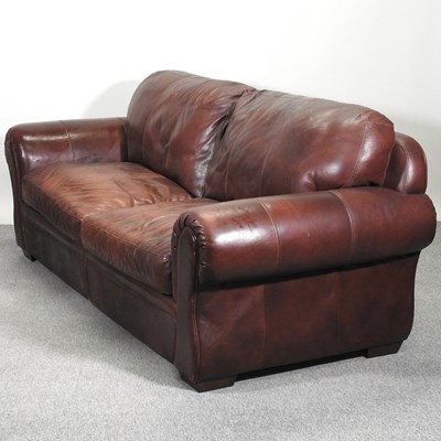 Lot 656 - A brown leather upholstered sofa