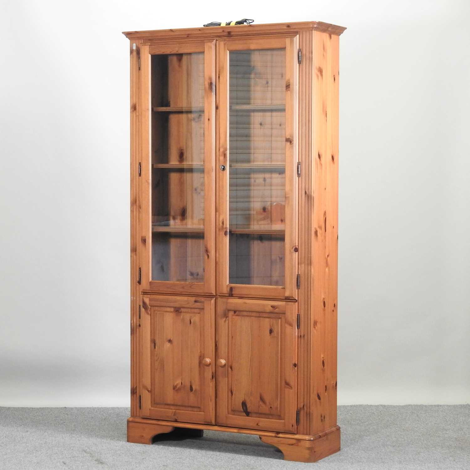 Lot 46 - A modern pine cabinet bookcase