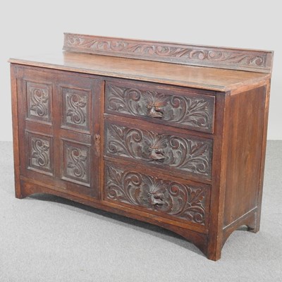 Lot 437 - An early 20th century carved oak sideboard