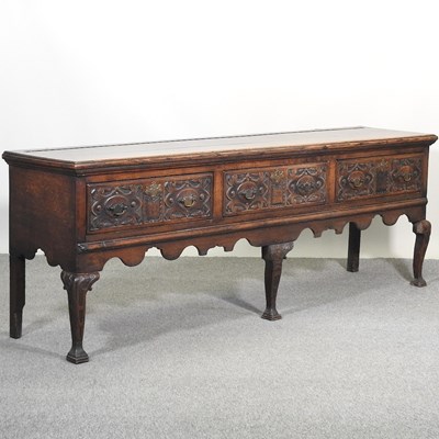 Lot 628 - An 18th century and later carved oak dresser base