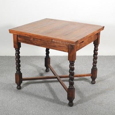 Lot 619 - A 1920's oak draw leaf dining table