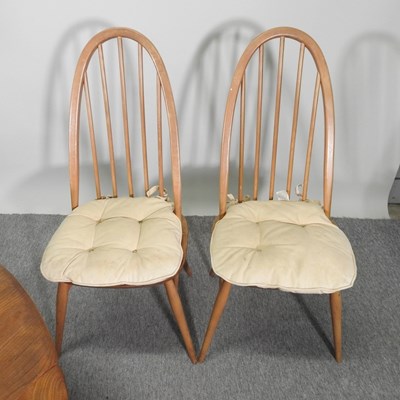 Lot 680 - An Ercol light elm dining table