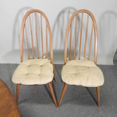 Lot 680 - An Ercol light elm dining table