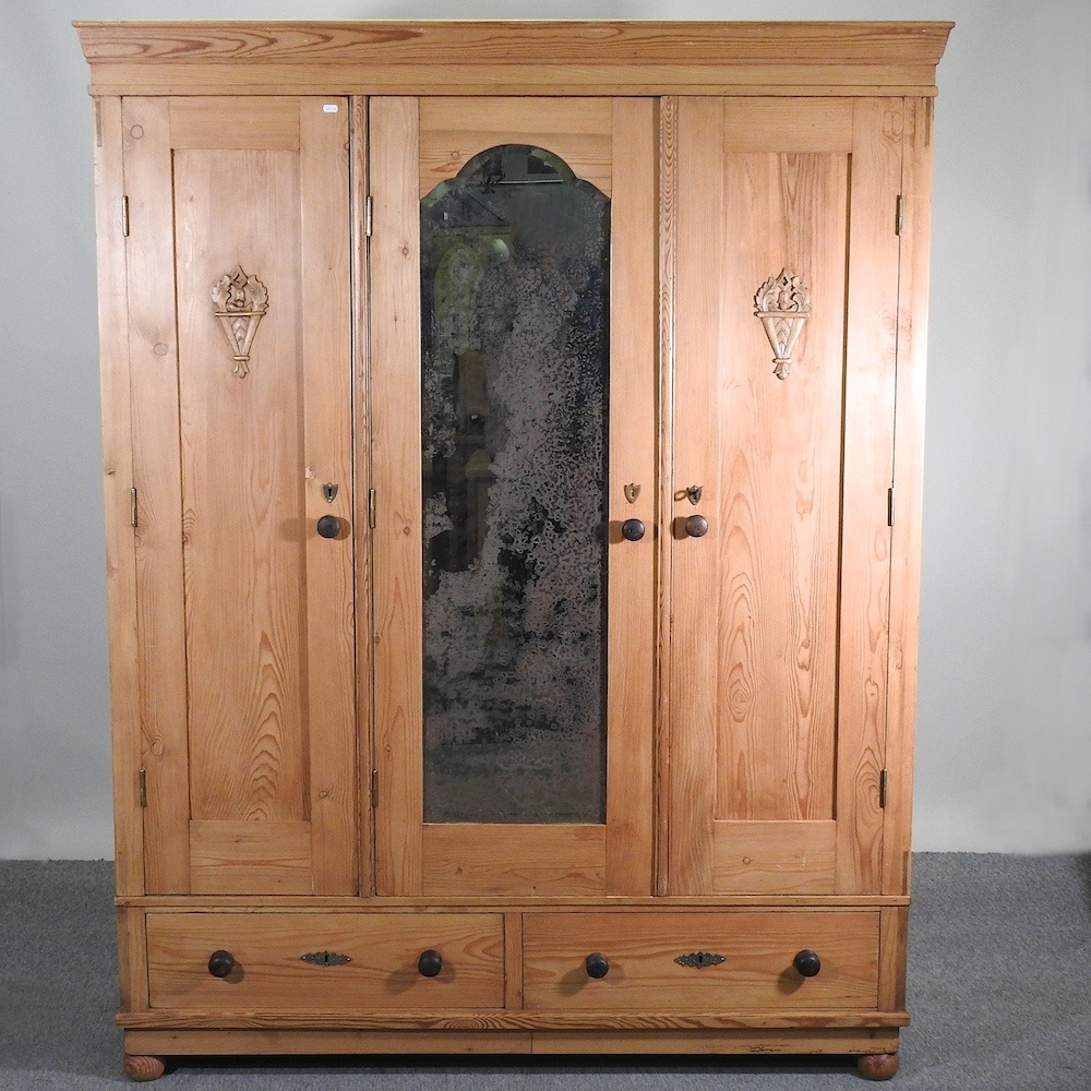 Lot 394 An antique pine armoire