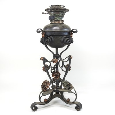 Lot 142 - An Arts and Crafts wrought iron oil lamp
