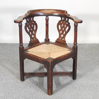 Lot 470 - A George III oak and elm corner chair