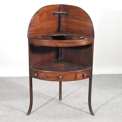 Lot 560 - A George III mahogany corner washstand