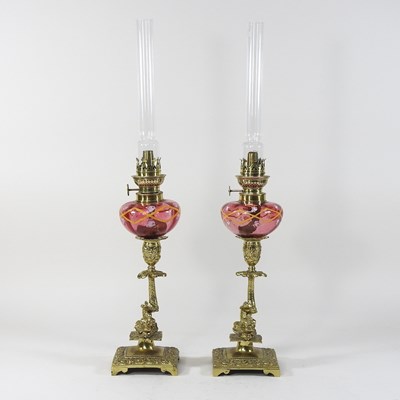 Lot 89 - A pair of 19th century brass and cranberry glass oil lamps
