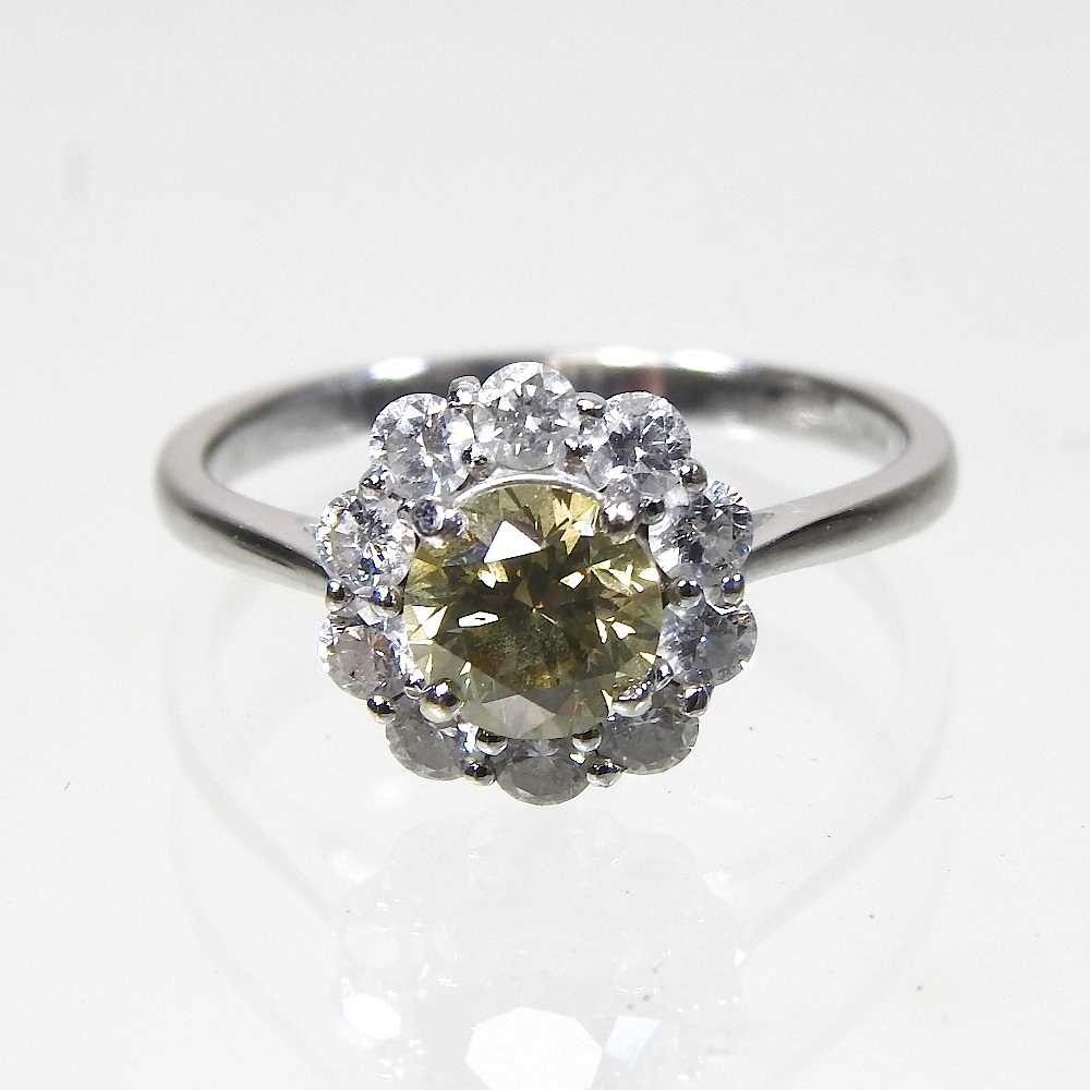 Lot 24 - An 18 carat white gold yellow diamond cluster ring