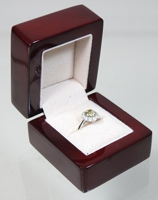 Lot 24 - An 18 carat white gold yellow diamond cluster ring