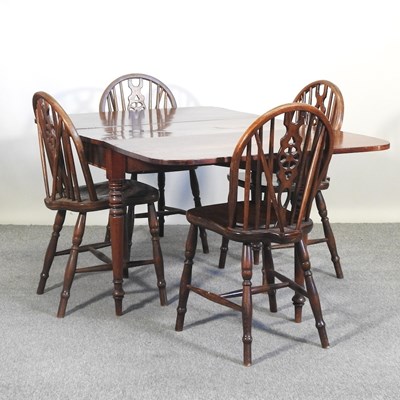 Lot 419 - A set of four wheel back dining chairs