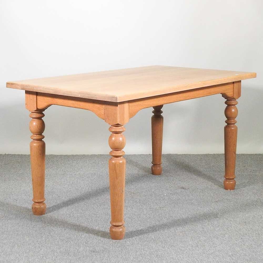 Lot 388 - A modern light oak dining table