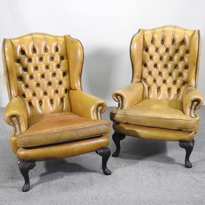 Lot 542 - A pair of button back wing armchairs