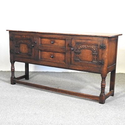 Lot 464 - A 20th century carved oak sideboard