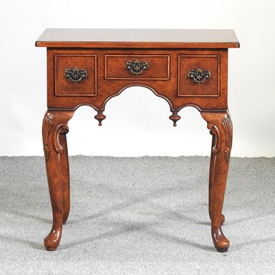 Lot 565 - A Georgian style burr walnut lowboy