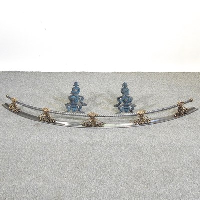 Lot 451 - An ornate polished steel and brass fender