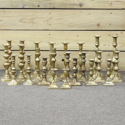 Lot 274 - Twelve pairs of brass candlesticks