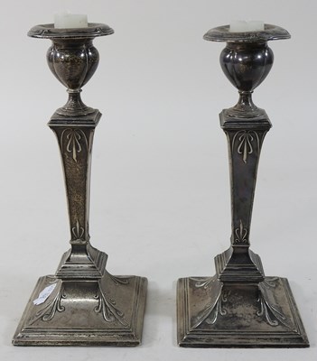 Lot 14 - A pair of Edwardian silver table candlesticks
