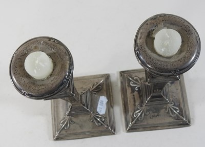 Lot 14 - A pair of Edwardian silver table candlesticks