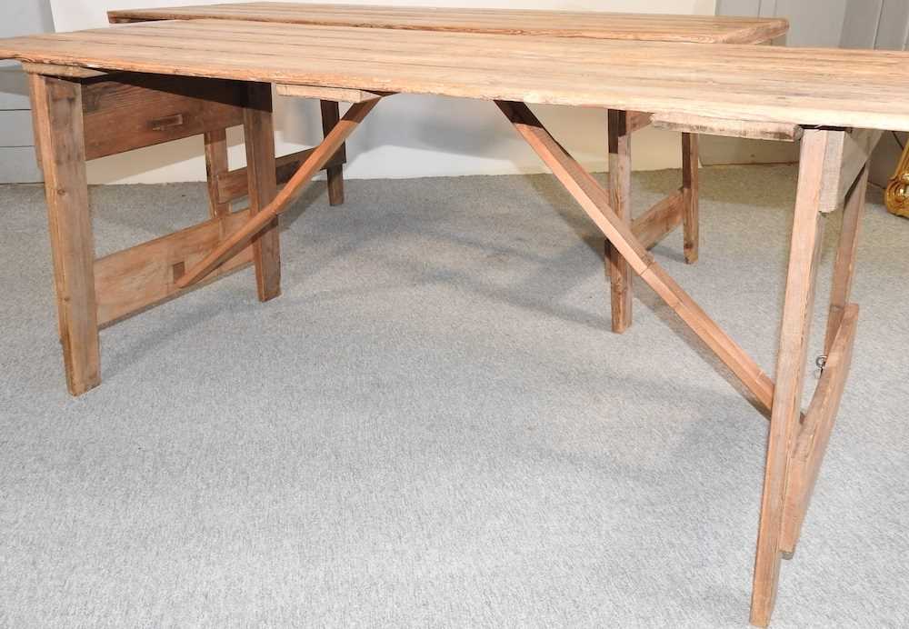 Lot 358 A folding wooden trestle table