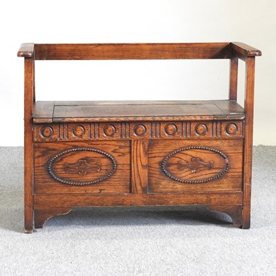 Lot 800 - A carved oak box settle