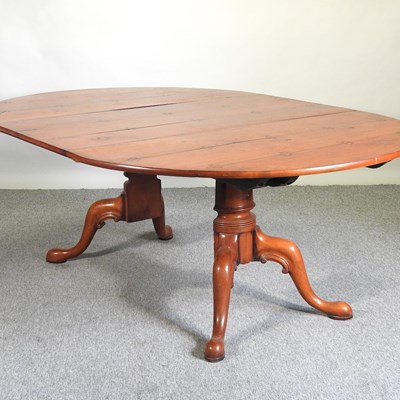 Lot 823 - A fruitwood dining table