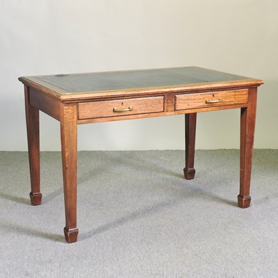 Lot 557 - A teak desk