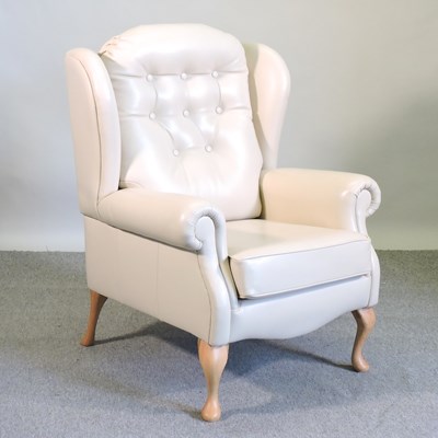 Lot 812 - A cream leather armchair