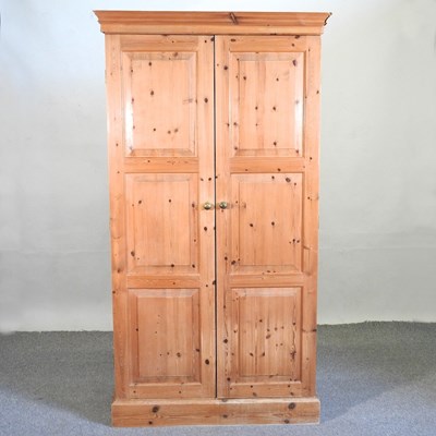 Lot 574 - A modern pine double wardrobe