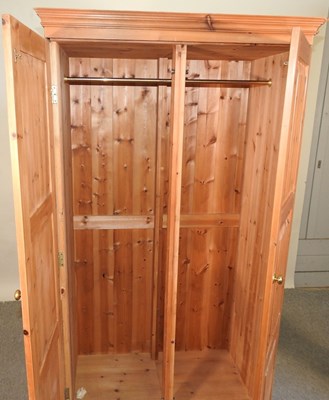 Lot 574 - A modern pine double wardrobe