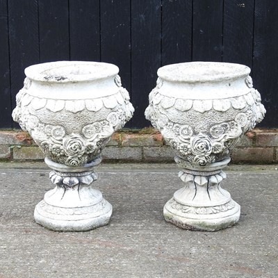 Lot 457 - A pair of cast stone garden urns