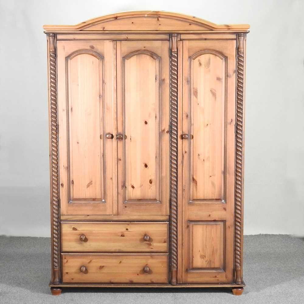 Lot 438 - A modern pine triple wardrobe