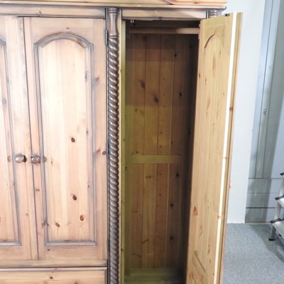 Lot 438 - A modern pine triple wardrobe