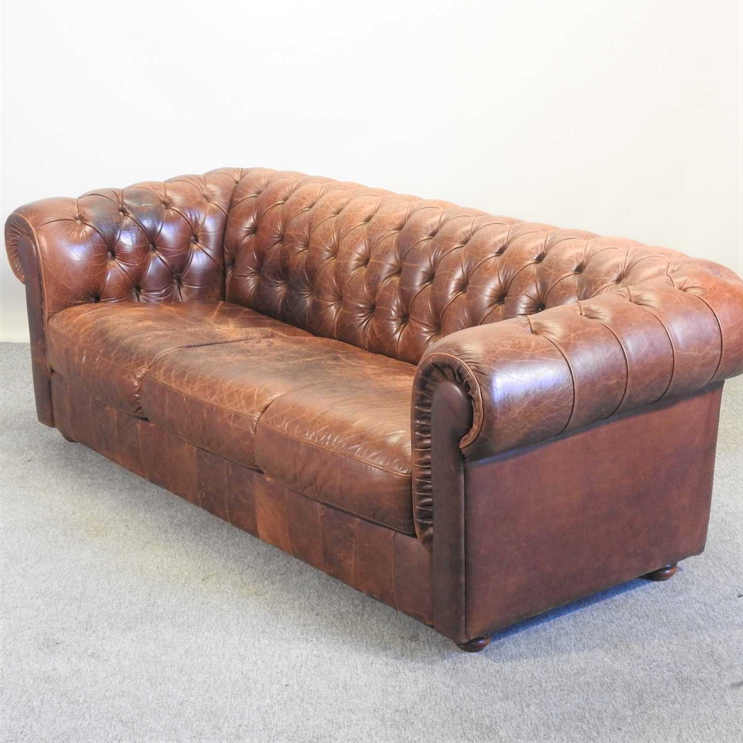 Lot 352 - A modern brown leather upholstered button back chesterfield sofa