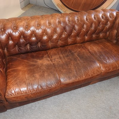 Lot 352 - A modern brown leather upholstered button back chesterfield sofa